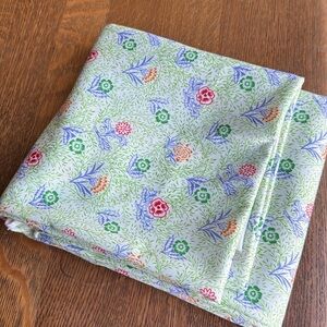 Floral stretch knit fabric, delicate floral print on pale green background